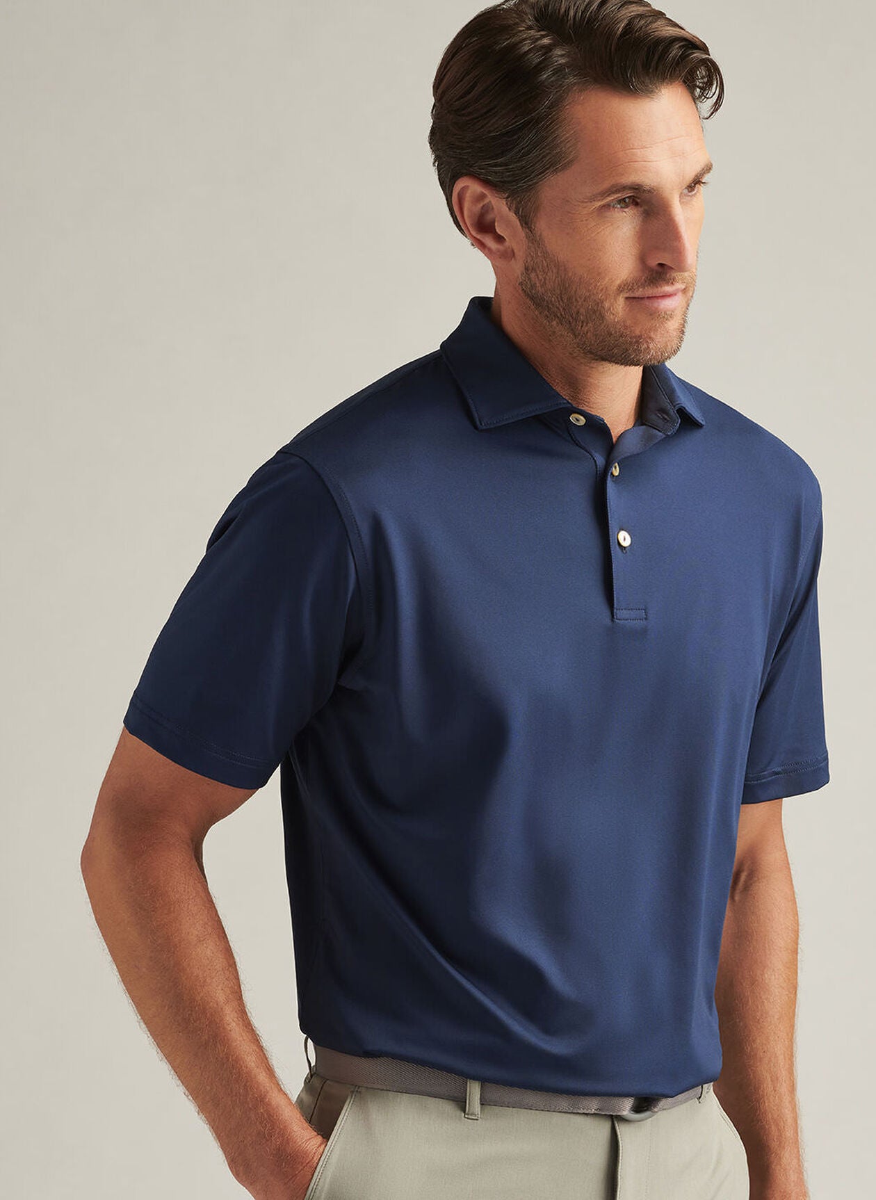 Man wearing a blue Peter Millar performance polo